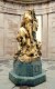 Liberty in Distress
The sculpture depicts a nude Liberty screaming in victory and sadness as the bodies of war dead fall and pile around her feet. The body of a nude male hangs over her proper right leg. She holds a broken sword in her proper left hand, as a dog, (representing Fidelity) and a rooster (representing France) stand at her feet. The sculpture is mounted upon an octagonal base with a wreath in relief on every other side. The temple is set upon a stepped base.